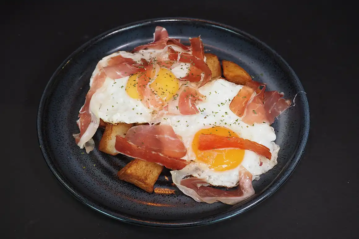 Fried eggs with potatoes and ham