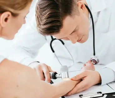 Doctor examining a patient's skin during a medical office.