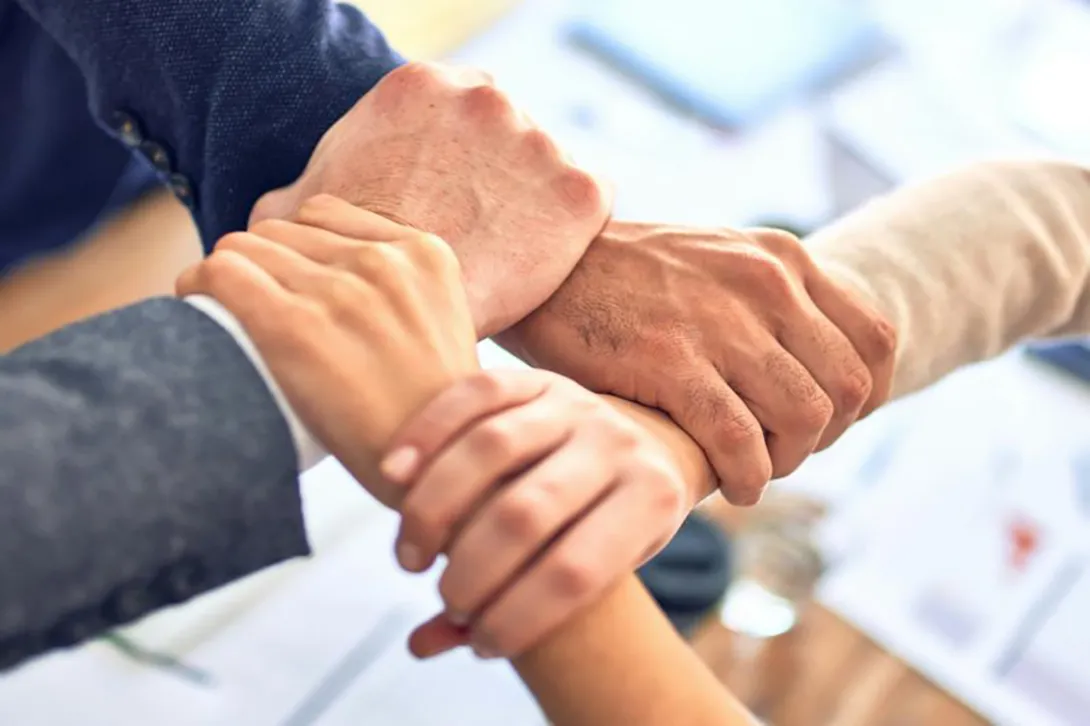 Holding hands, a symbol of unity and strength.