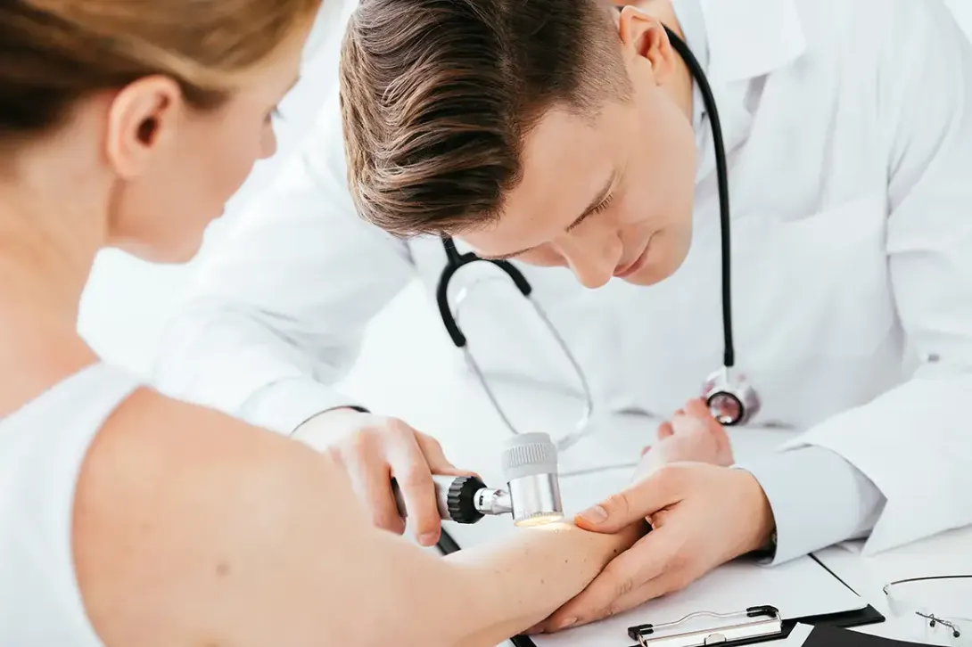 Doctor examining a patient's skin during a medical office.